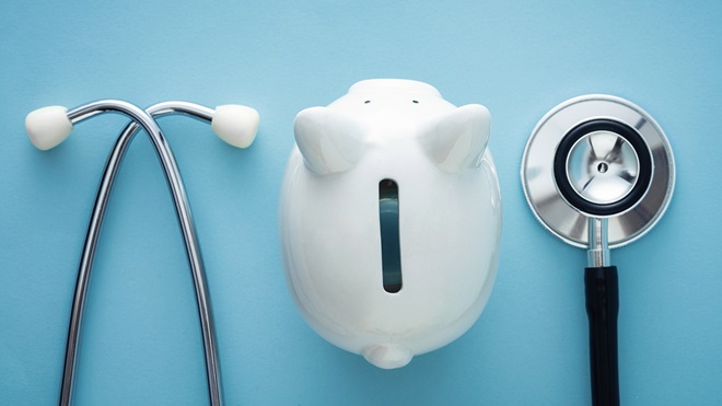stethoscope and a white piggy bank on a blue background